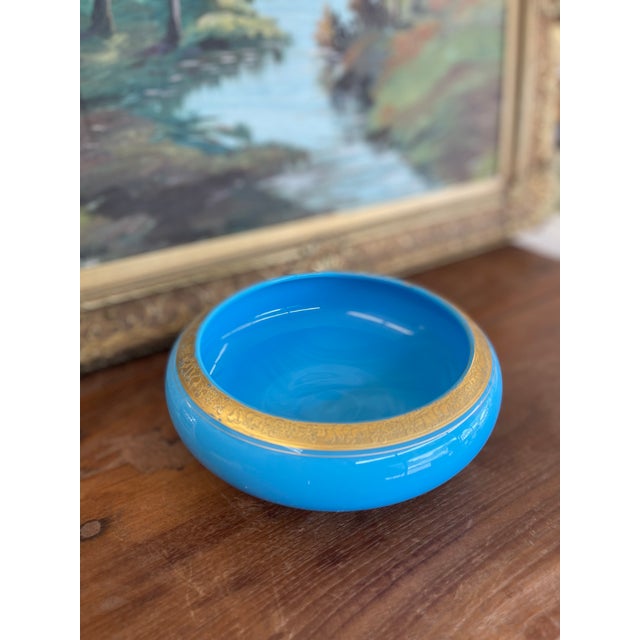 A fine example of 19th-century French opaline glass, this vibrant sky-blue bowl showcases the luminous, semi-translucent...