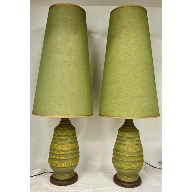 Pair of great vintage ceramic lamps with original unique very tall shades. Marked “Plasto Mft. Co”on bottom edge. Faux-...