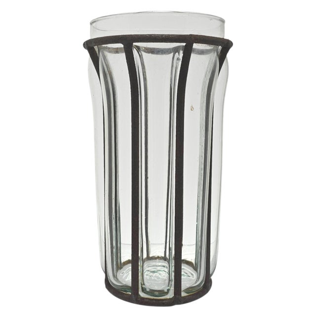 Transparent bubble glass framed by weathered iron gives this caged glass vase its distinctive architectural presence. The...