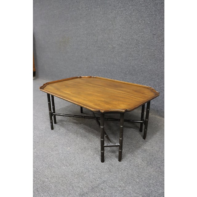 Chinese Chippendale–style coffee table by Kittinger Furniture. This piece features a rectangular wood top with shaped...