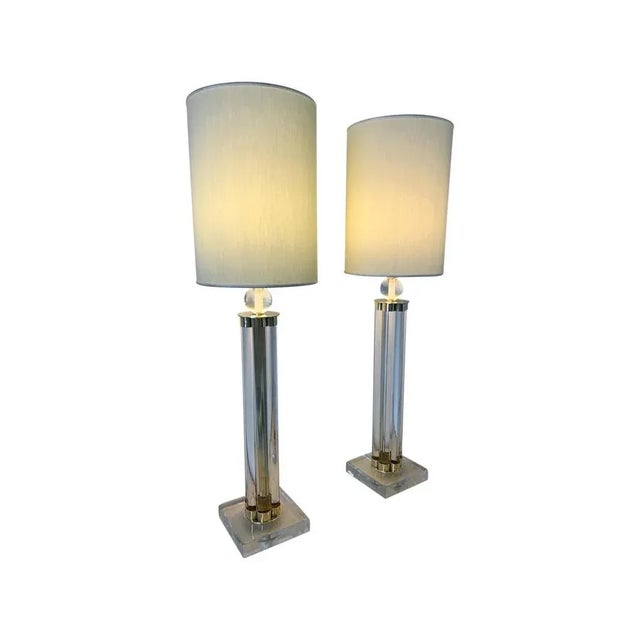 This pair of Murano lamps was produced in Italy in the early 2000s. The lamps are completely in Murano glass and brass...