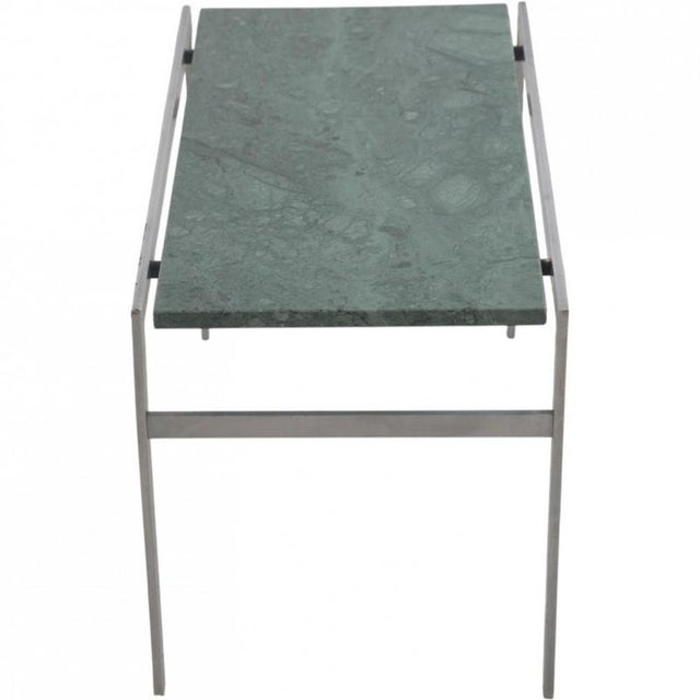 Fabricius and Kastholm side table with a table top of green marble and a frame of brushed stainless steel. The table is...