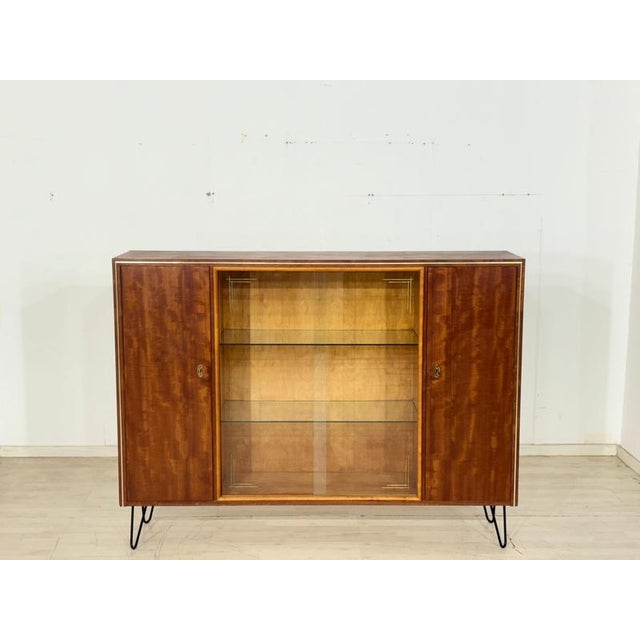 A stylish mid-century highboard from the 1960s. This piece of furniture impresses with its clean lines, the elegant...