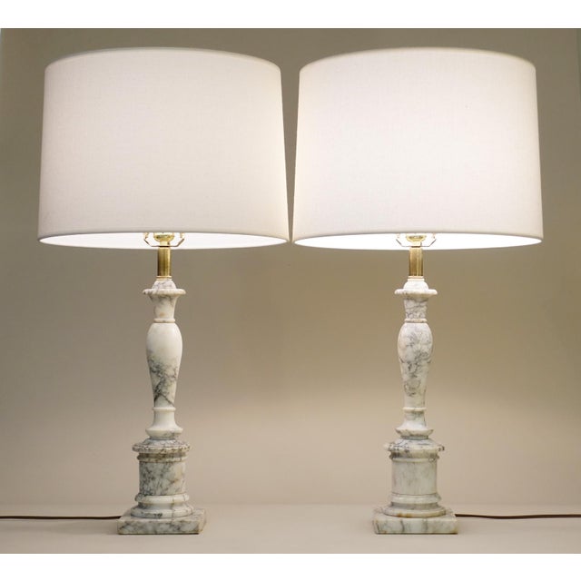A striking matching set of large Italian Carrara marble Classic Hollywood Regency Tuscan Column style table lamps from...