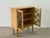 A captivating solid oak display cabinet with leaded stained glass doors in the style of Henning Kjærnulf, combining the...