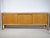 Danish Design teak sideboard by Bramin, 1960s. Long cabinet with three sliding doors, round recessed handles, and a...