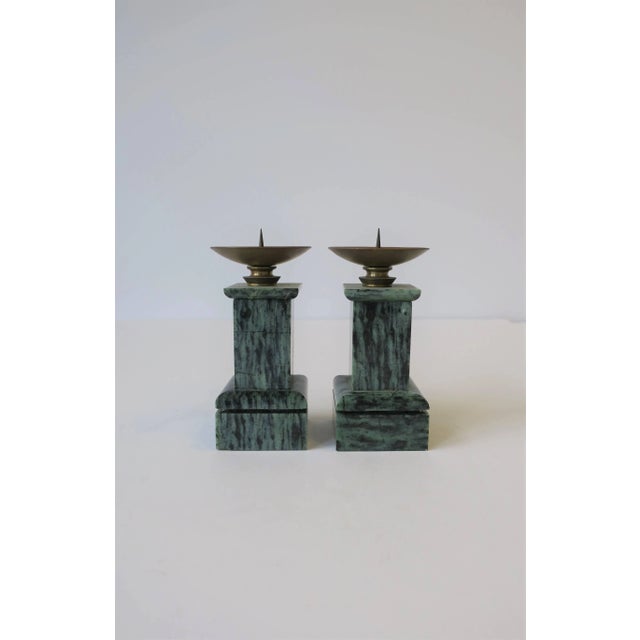 A beautiful pair of small well vintage dark green and black marble, column design, candlestick holders with brass top, in...