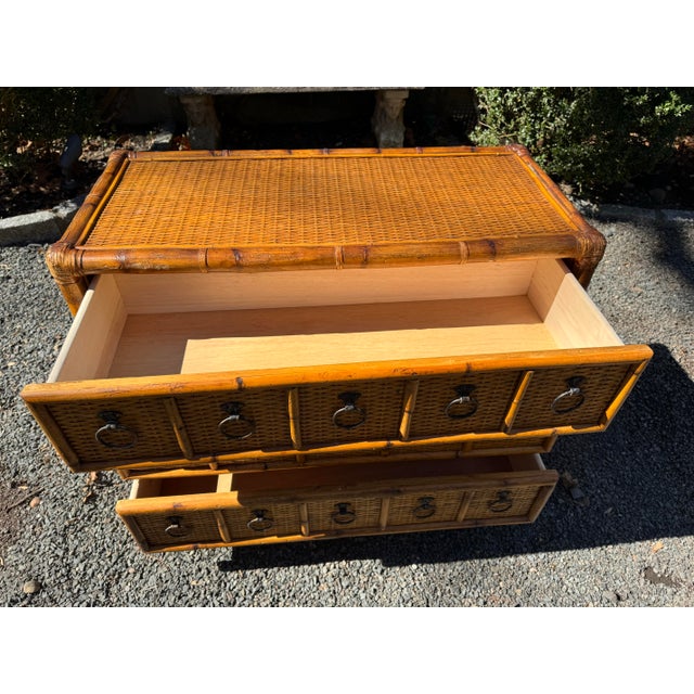 A handsome vintage bamboo, wood and rattan chest of drawers. The chest includes three identical and sizable drawers that...