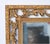 A large vintage rectangular gold tone Italian Baroque style wall mirror with a warm, slightly worn golden tone with traces...