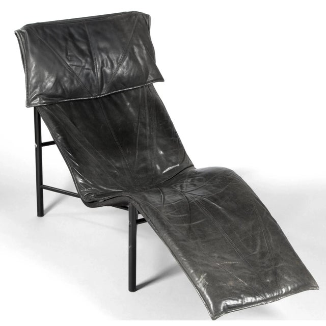 Leather chaise longue by Lord Bjorklund, the design features an architectural black steel tube frame with a curvy...