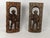 A distinctive pair of mid-20th-century hand-carved wood figural relief panels depicting traditional watchman or guard...