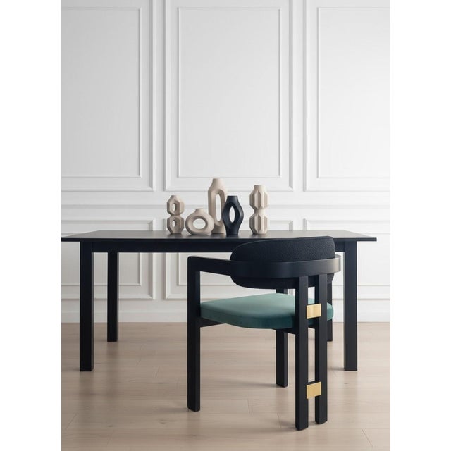 Elevate your dining experience with the Conan Arm Dining Chaira perfect blend of modern comfort and sculptural elegance....