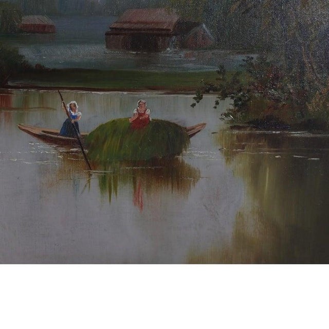 An antique oil on canvas painting depicts a serene river scene. The work, dating to approximately 1890, captures a...