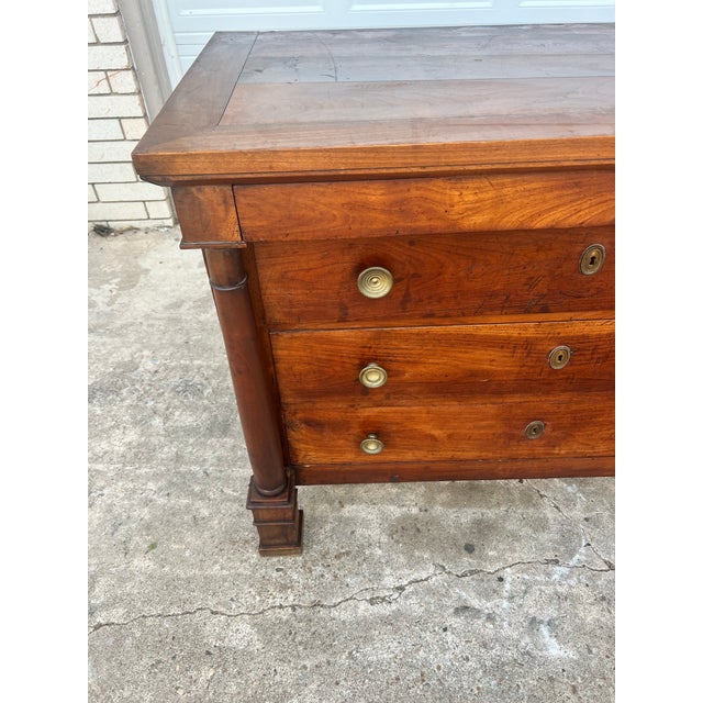 A handsome French Empire chest of drawers crafted in the 19th century from richly figured walnut. Featuring three spacious...