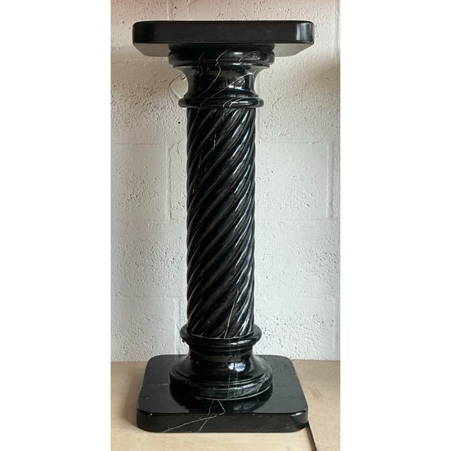 An exquisite vintage Italian pedestal crafted from luxurious black marble. Intricately carved with elegant details, this...