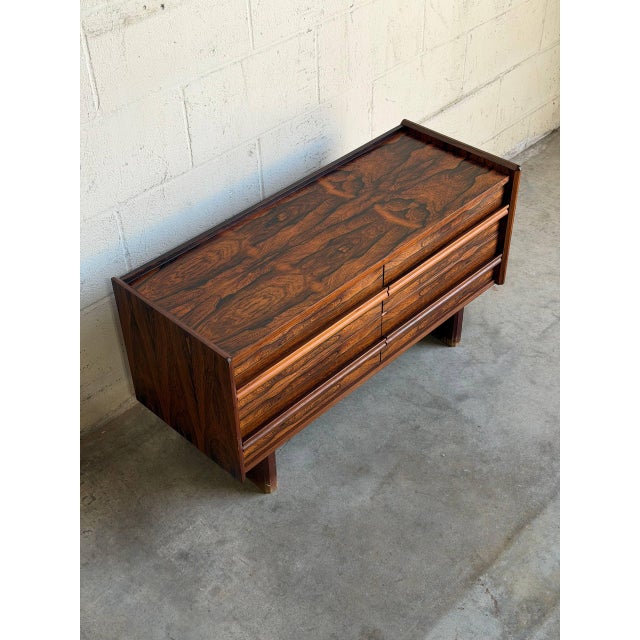 This exceptional low-profile chest displays a streamlined rectangular silhouette supported by substantial slab legs. Four...