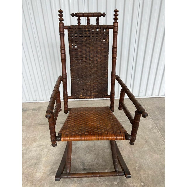 The bottom portion of the seat must have been rewoven at some point in this chair’s history as the seat appears to be...