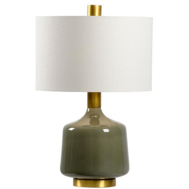 Create a sleek modern look in your space with tremont lamp. Featuring a glossy olive glazed ceramic, this table lamp has a...