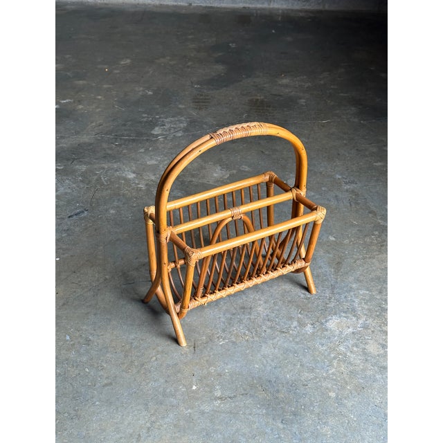 Wonderful modernist magazine rack with great details. Features two sides with a divider. Bamboo frame with reed wrapped...