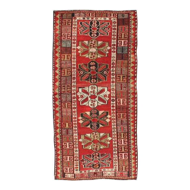 Antique Kazak Runner With Seven Medallions and Tribal Design in Red Background For Sale
