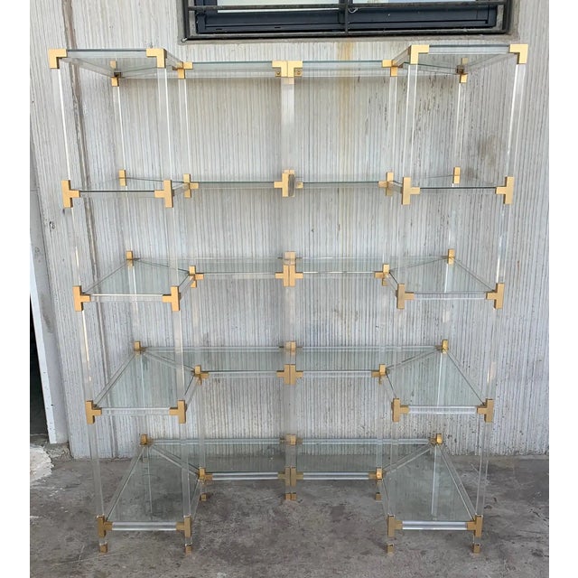Midcentury pair of brass Lucite and glass corner étagères. Five shelves We have three corner etageres available and one...