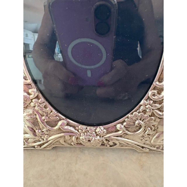 Hearts and Flowers... Love is All That Matters! This Sterling Silver frame is decorated with numerous playful poutti...