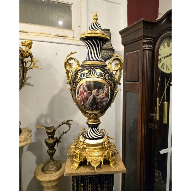 This monumental Baroque-style porcelain vase is an extraordinary decorative statement piece finished in rich black tones...