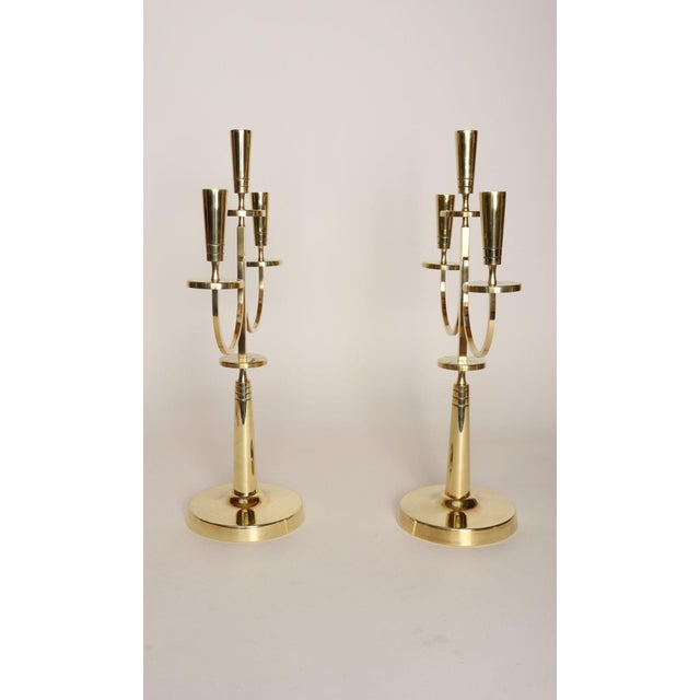 Pair of large solid brass sculptural candelabra by Tommi Parzinger for Dorlyn Silversmiths (ca. 1950s, USA). Majestic...
