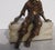 Hirsch bookend figure of the Pirate with a gun. A zinc figure on a block of white banded onyx. Polychromed in bronze-...