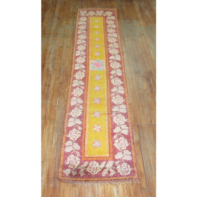 An mid 20th Century bright yellow runner with floral field and medallion. This piece is a one of a kind vintage rug that...