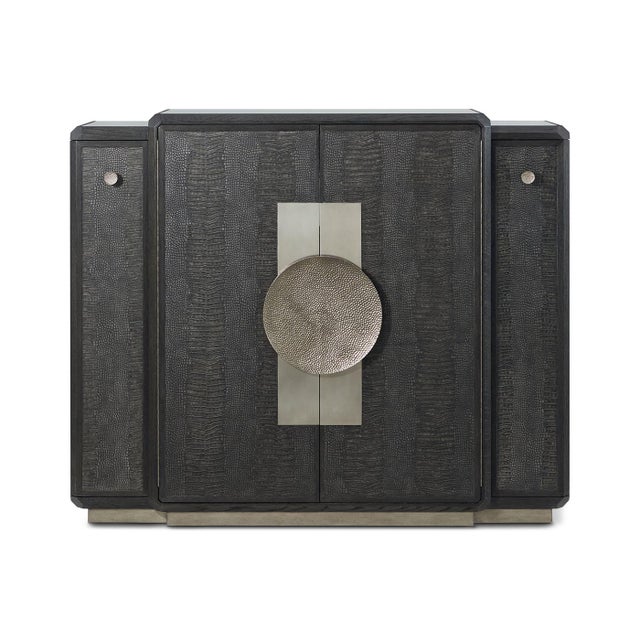 Crafted from oak and finished in a rich dark Onyx tone, this striking cabinet is adorned with crocodile-embossed leather...