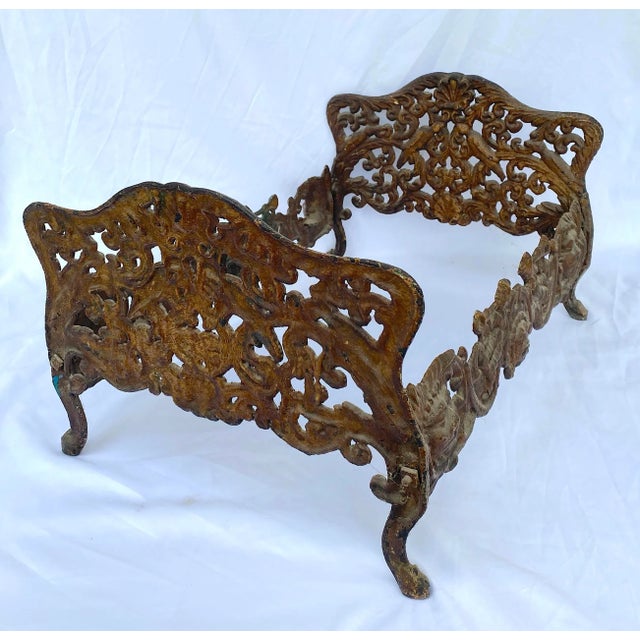 Very rare and ornate late 1800s antique iron doll/pet bed frame. The bed frame depicts persons playing musical...
