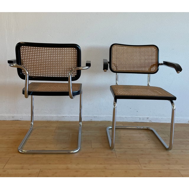 Tubular chrome-plated steel cantilever frame. Hand-woven cane (ratten) seat and backrest. This piece has an attribution...