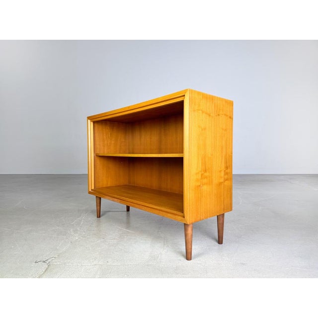 Beautiful small WK Möbel sideboard from the 1960s. The sideboard has two doors and is made of high-quality walnut wood....