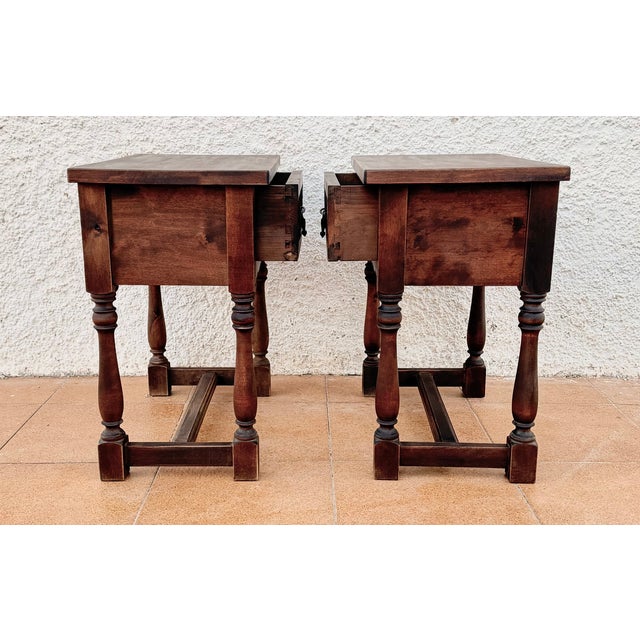 Charming pair of Spanish bedside tables dating from the mid-20th century. Crafted in wood, each table features a single...