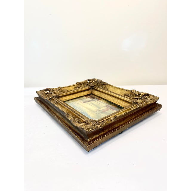 Beautiful vintage or antique oil on board painting depicting two sailboats in a substantial and ornately carved gold wood...