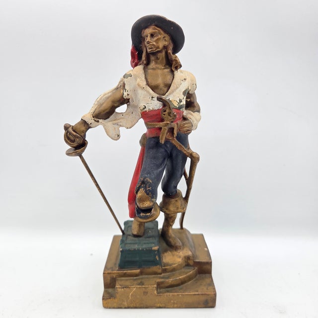 A striking pair of antique Armor Bronze Co. bronze-clad bookends featuring dramatic swashbuckling pirates poised with...