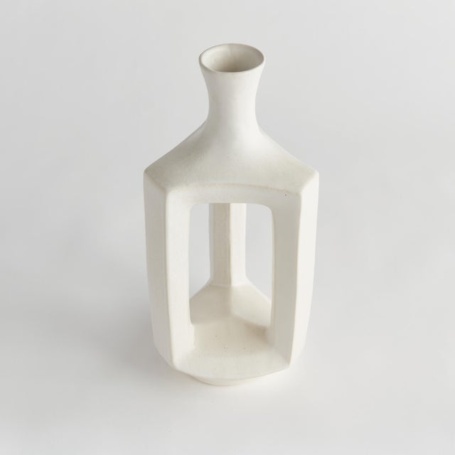 Simple and wide open in form with a matteWhite glaze, this decorative vase is a truly modern accent. Perfect for a single...