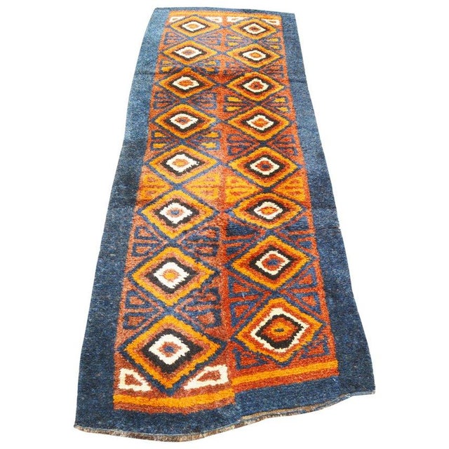 Hand-knotted with care using traditional rug-making techniques, this wool rug blends timeless craftsmanship with a modern...