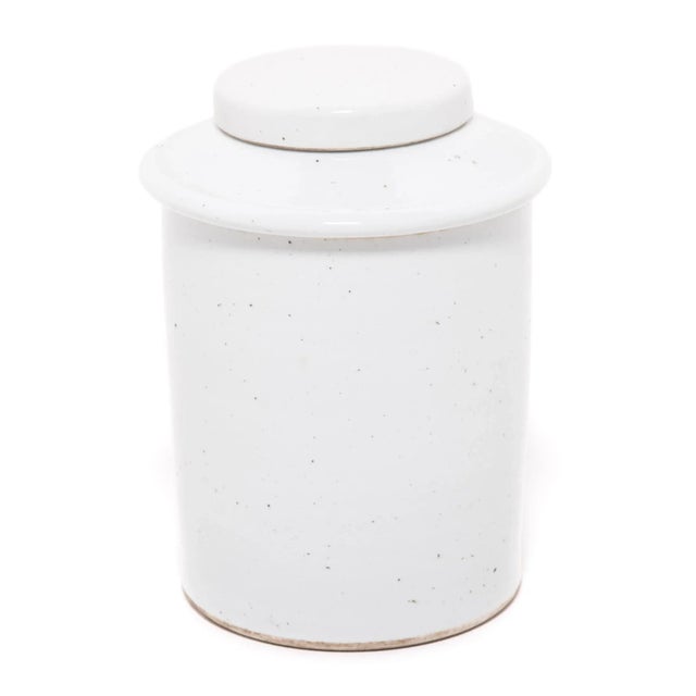 Rendered in a striking cool white glaze, this contemporary porcelain jar offers a modern take on a classic form. Lidded...