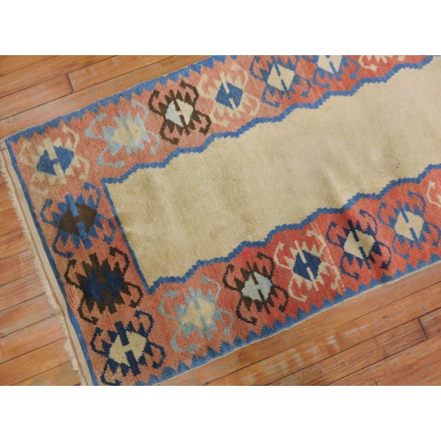 A narrow runner mid-20th century Turkish runner resembling American Navajo rugs.