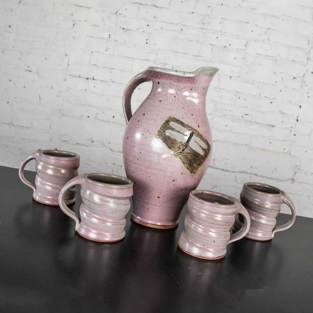 Lovely purple ceramic handmade hot chocolate set includes one pitcher and four cups signed Powell. Beautiful age-...