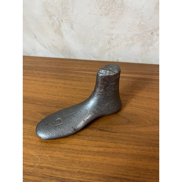 An authentic antique shoe last made of metal. This piece, once used by shoemakers, is now a decorative object prized for...