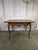 An exquisite late 19th-century French Provincial center table in the Louis XV manner, rendered in warm, honeyed solid oak...