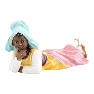 Vintage Petite English Porcelain Figurine Depicting a Young Girl Laying on the Ground