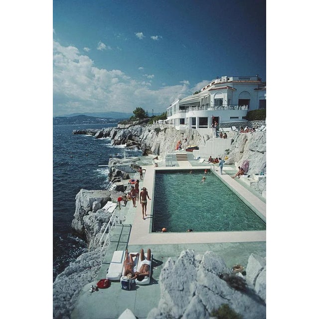 Hotel du Cap Eden-Roc 1976 by Slim Aarons printed 2024 Slim Aarons Limited Estate Edition Guests by the pool at the Hotel...