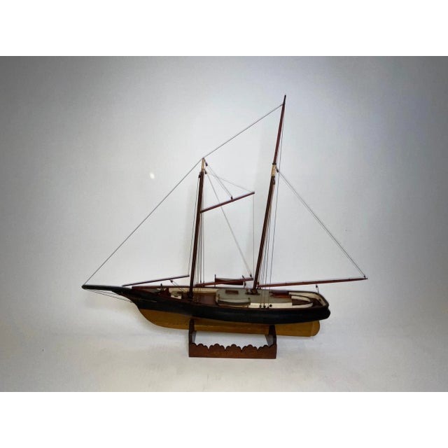 Fine antique ship model of the schooner yacht "Vim" of 1865. The sleek hull is painted black over gold. The deck carries a...