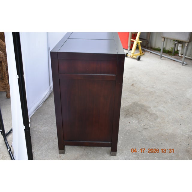 The minimalist design is elevated by subtle industrial detailing, including exposed hardware accents and sleek brass-...