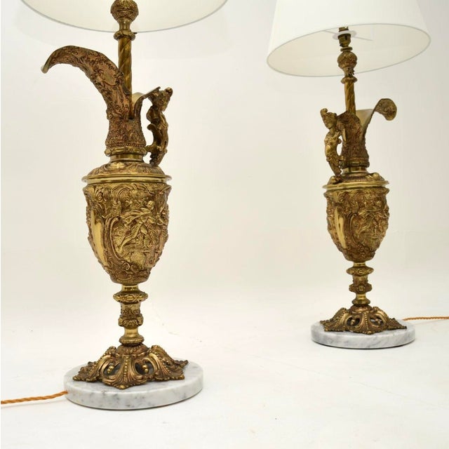 A stunning pair of antique French gilt metal and marble table lamps, dating from around the 1930’s. They are large and...