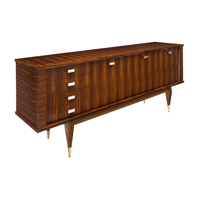 Buffet from the mid-century period in France. This piece is made of solid wood construction and features a striking...